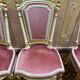 Louis XVI dining room table set with painted wood, gold accents, and pink velvet.