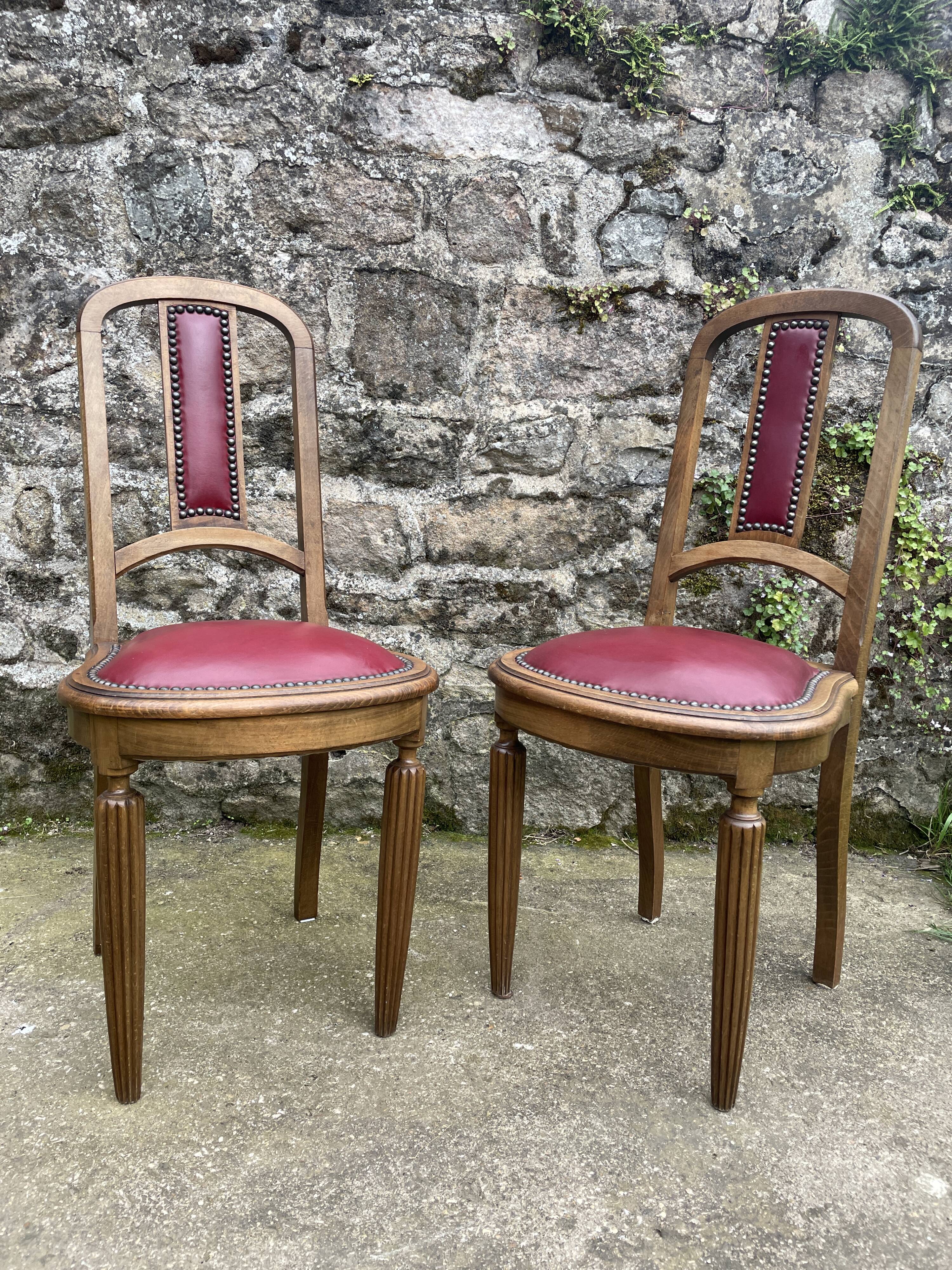 Pair of studded burgundy leather Art Deco chairs