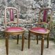 Pair of studded burgundy leather Art Deco chairs