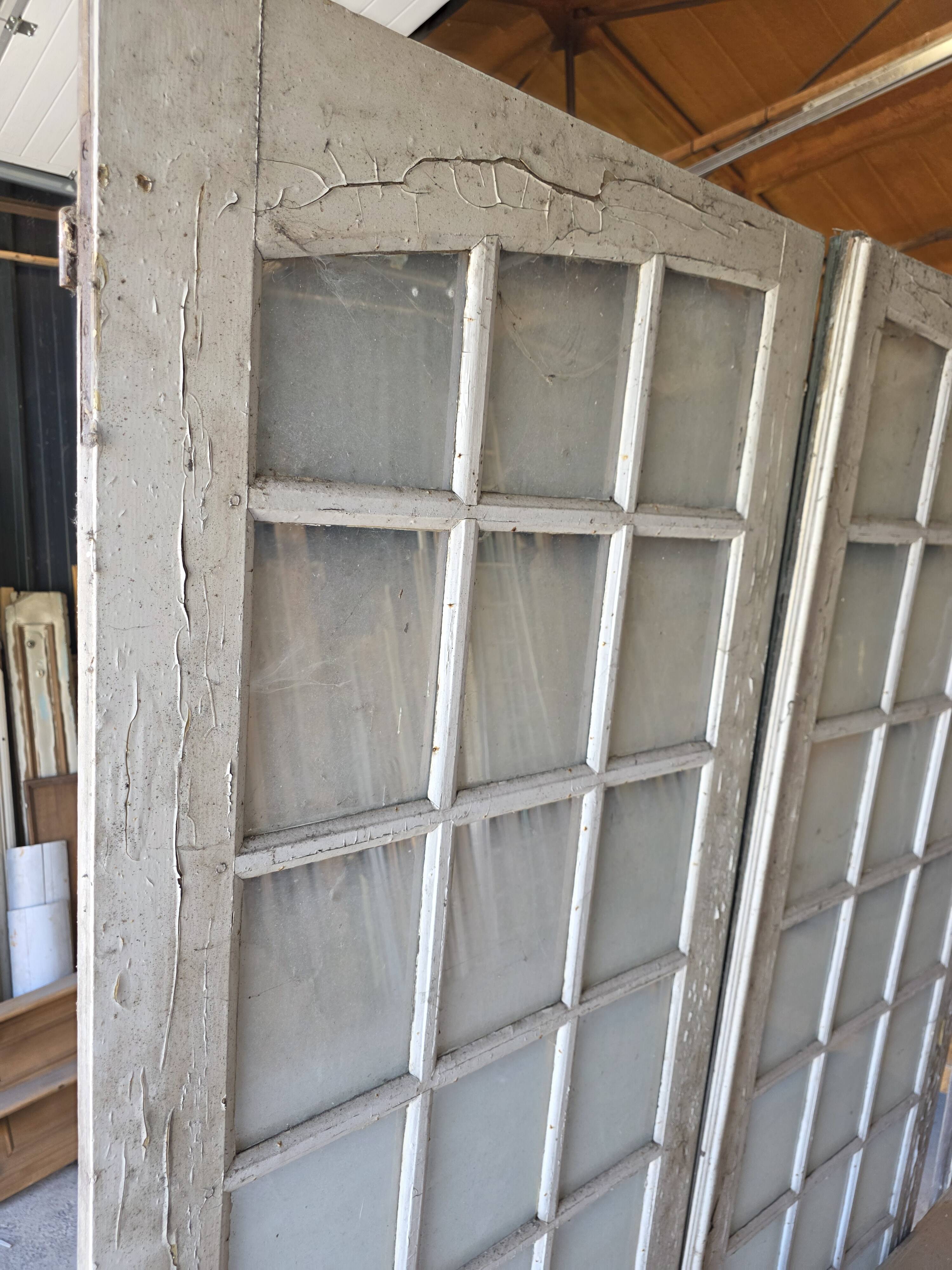 Two pairs of solid oak doors with small panes.