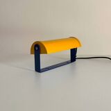 Adjustable wall lamp in yellow and blue.