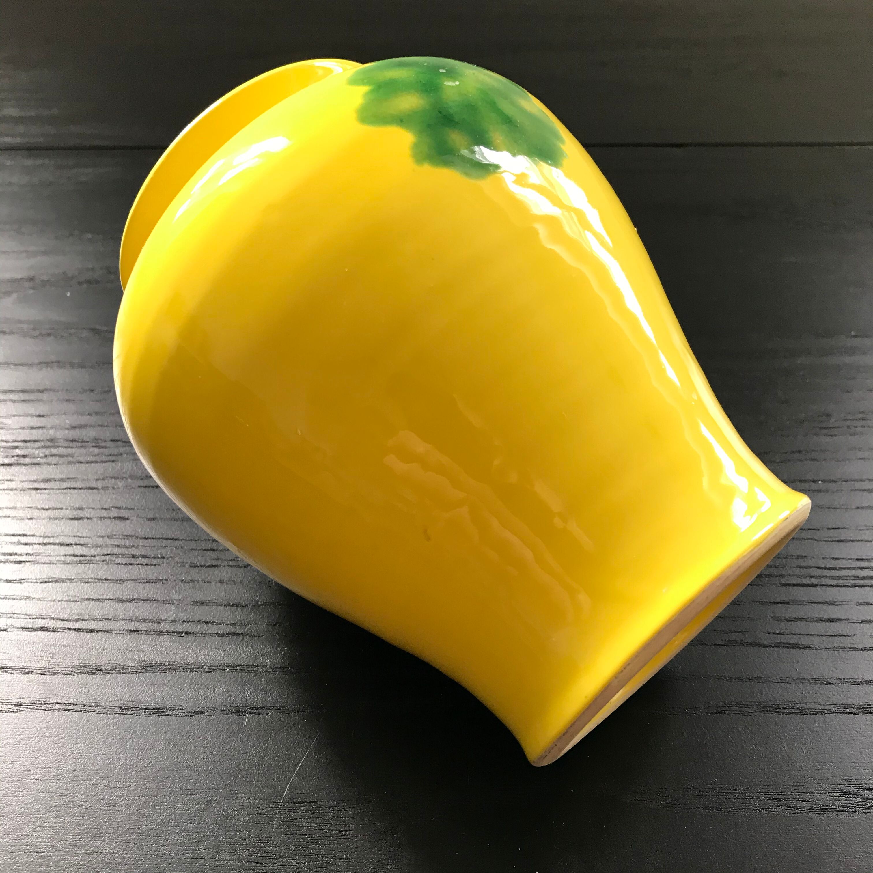 Yellow vase with green spots.