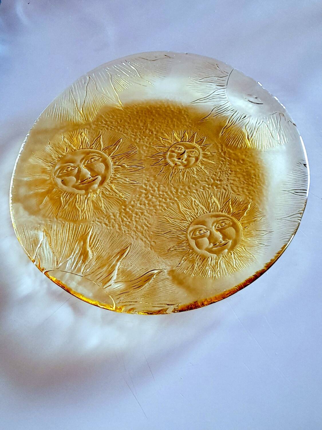 Glass plate decorated with suns, 1980.