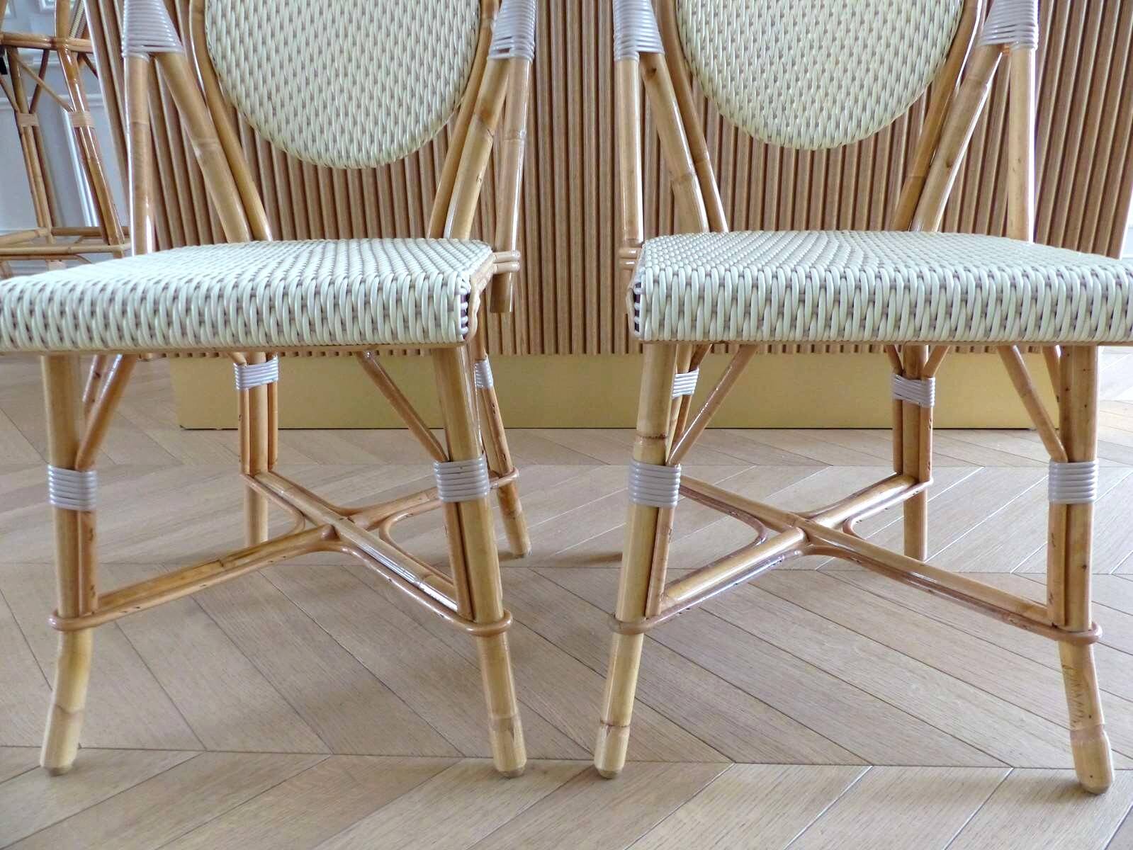 Pair of Parisian bistro chairs from Maison Louis Drucker in light Manila rattan.