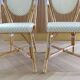 Pair of Parisian bistro chairs from Maison Louis Drucker in light Manila rattan.