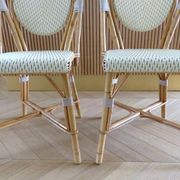 Pair of Parisian bistro chairs from Maison Louis Drucker in light Manila rattan.