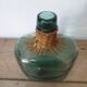 Demijohn with her rattan necklace