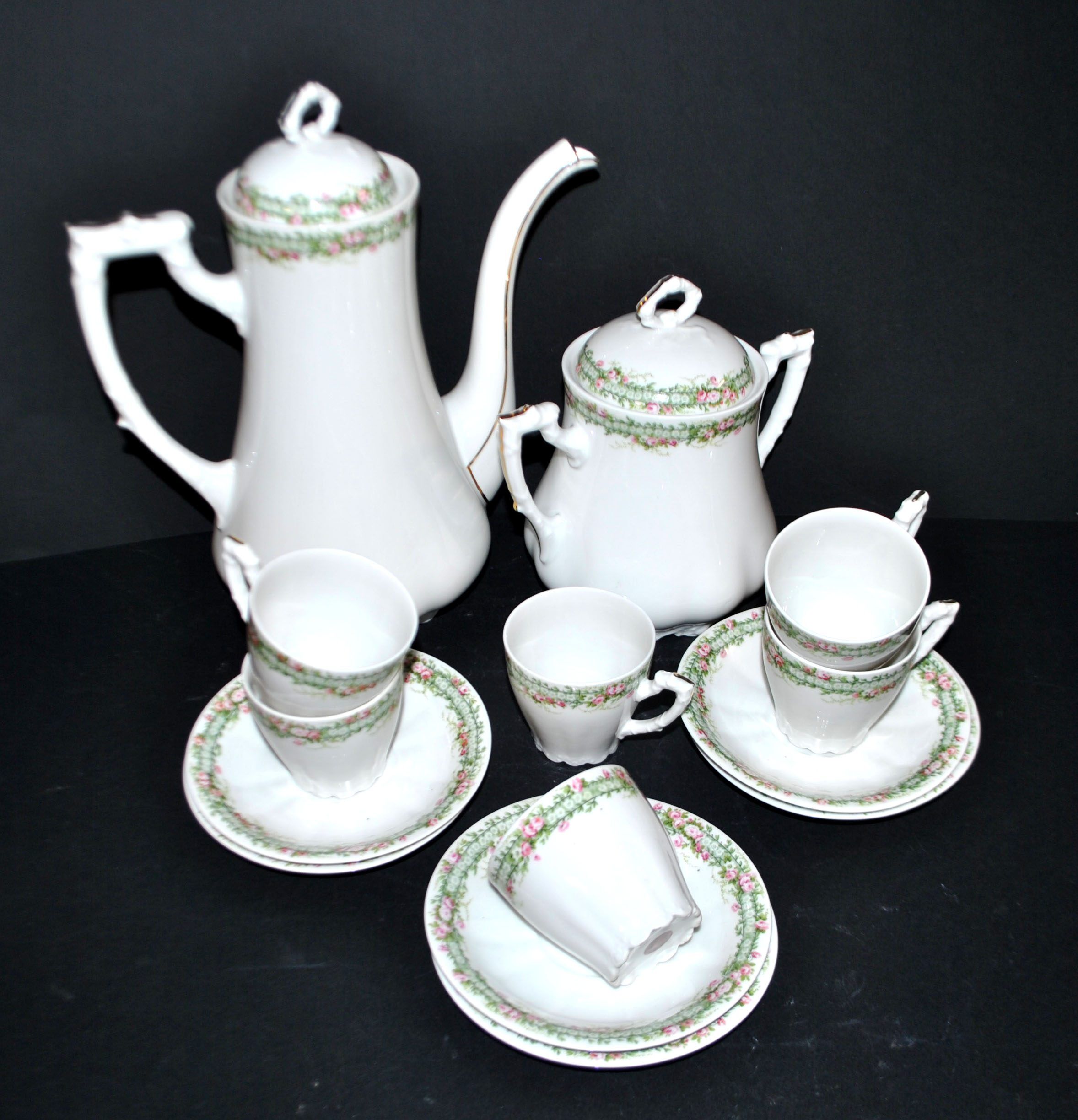 Vintage Limoges coffee service with pink and green floral decoration, coffee pot, sugar bowl, and 6 cups.
