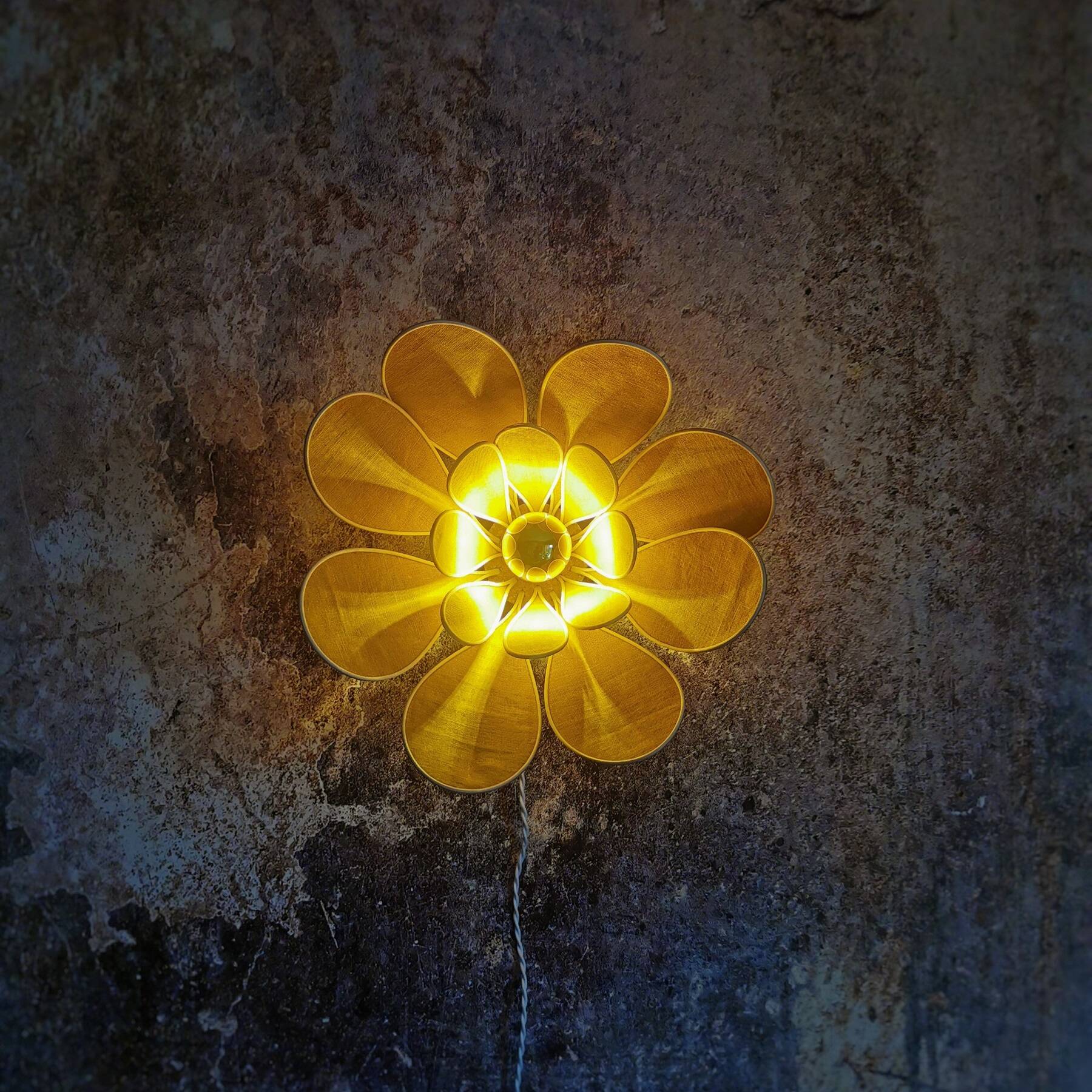 Flower wall light made of rattan and saffron linen petals