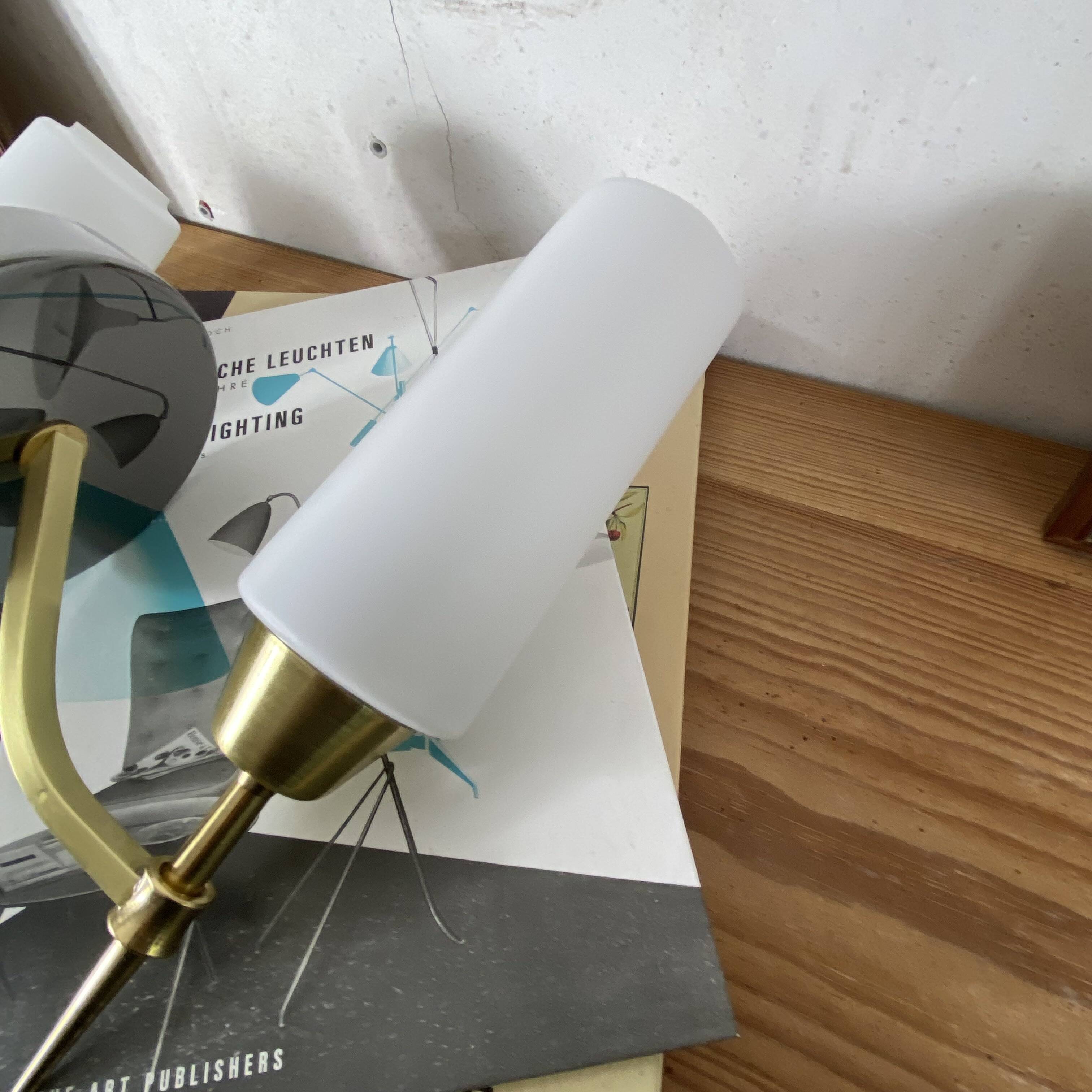 Pair of wall sconces in brass with white glass tulips.