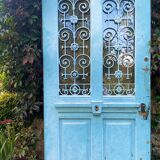 Entrance door in solid oak, cast iron grille, 1930s