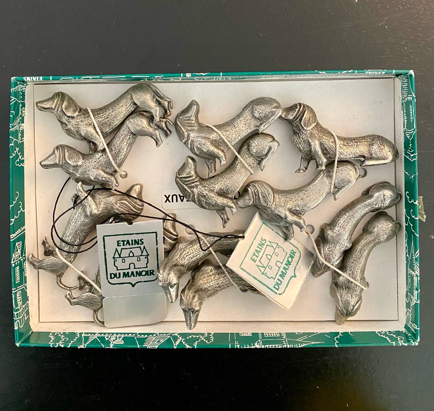 12 old dog-shaped Etains du Manoir knife holders