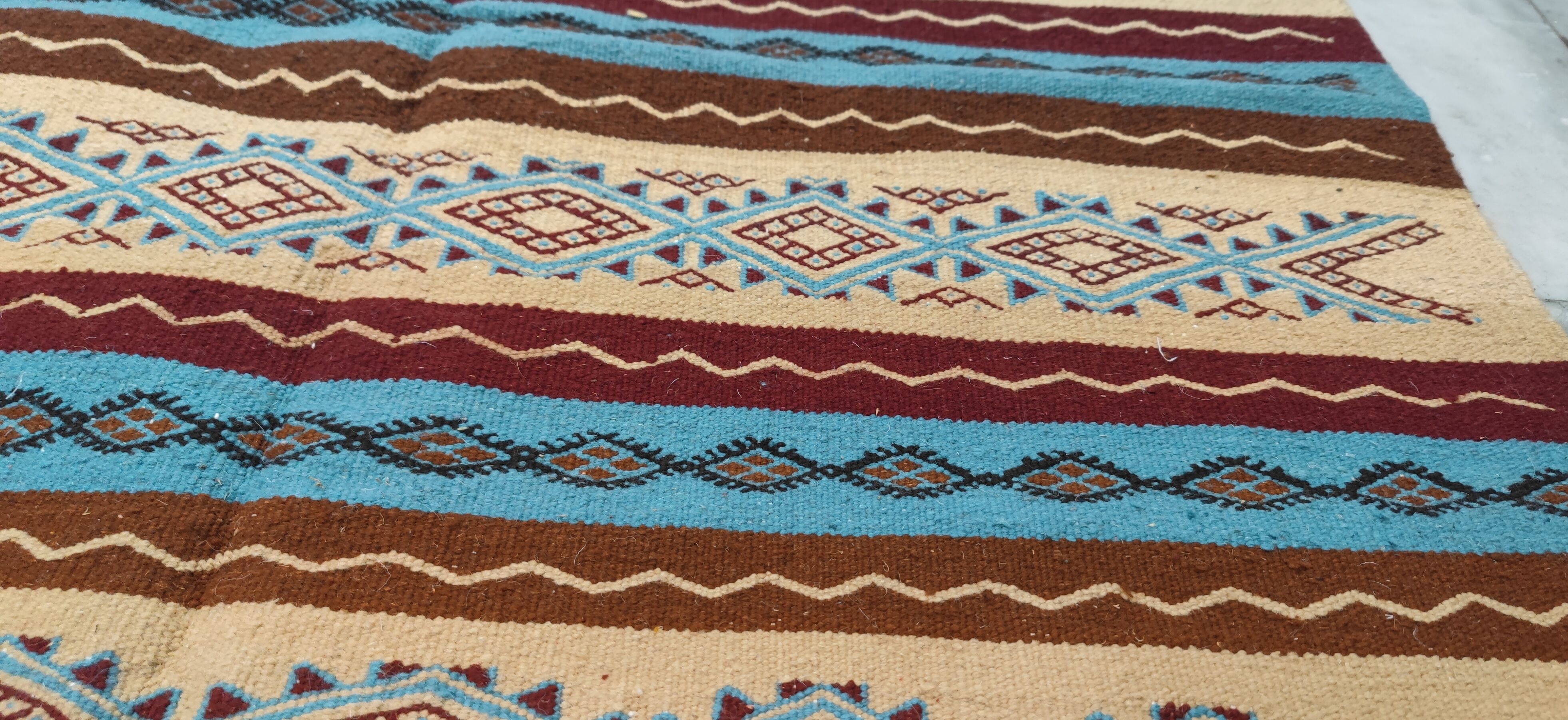 Multicolored hand-woven Berber rugs in natural wool