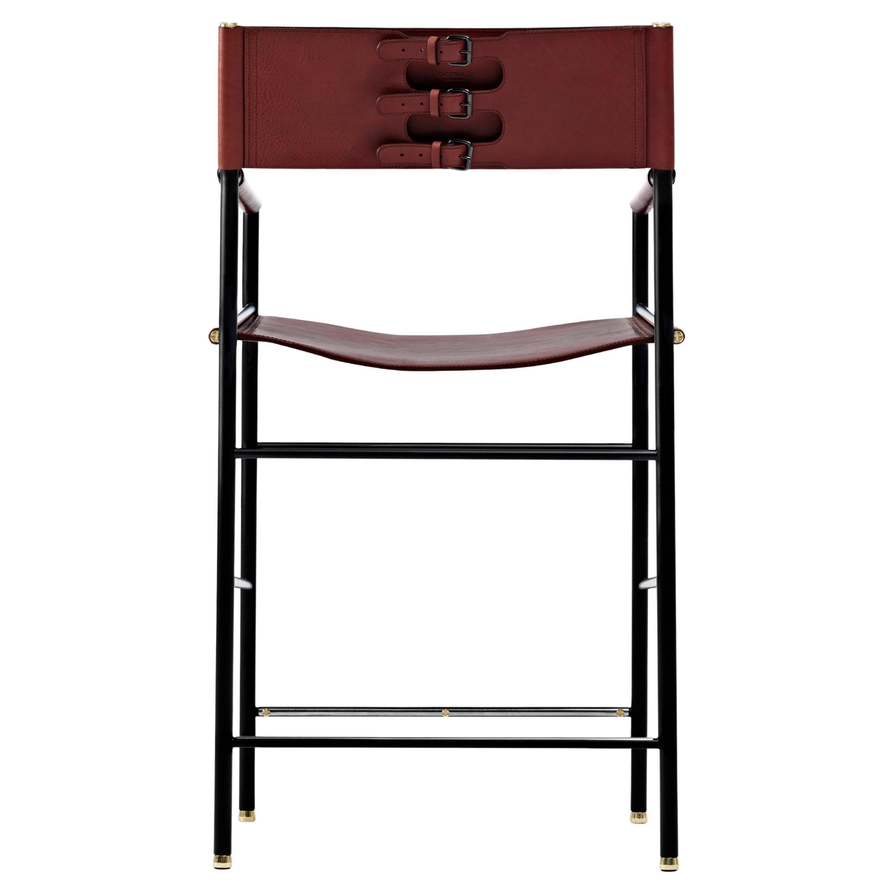 Contemporary classic bar stool with cognac leather backrest and black rubber metal.