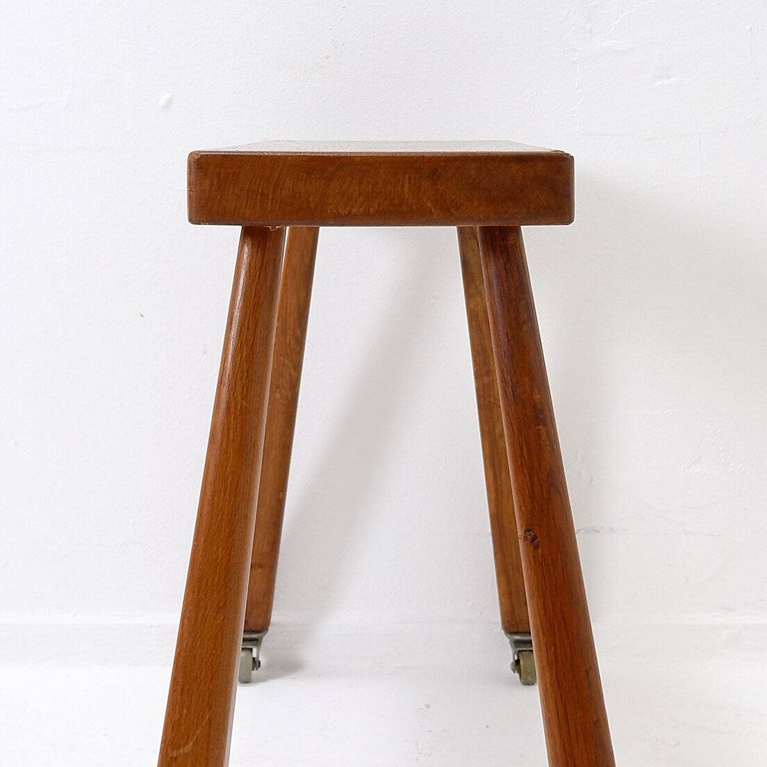 Vintage solid wood side table on casters