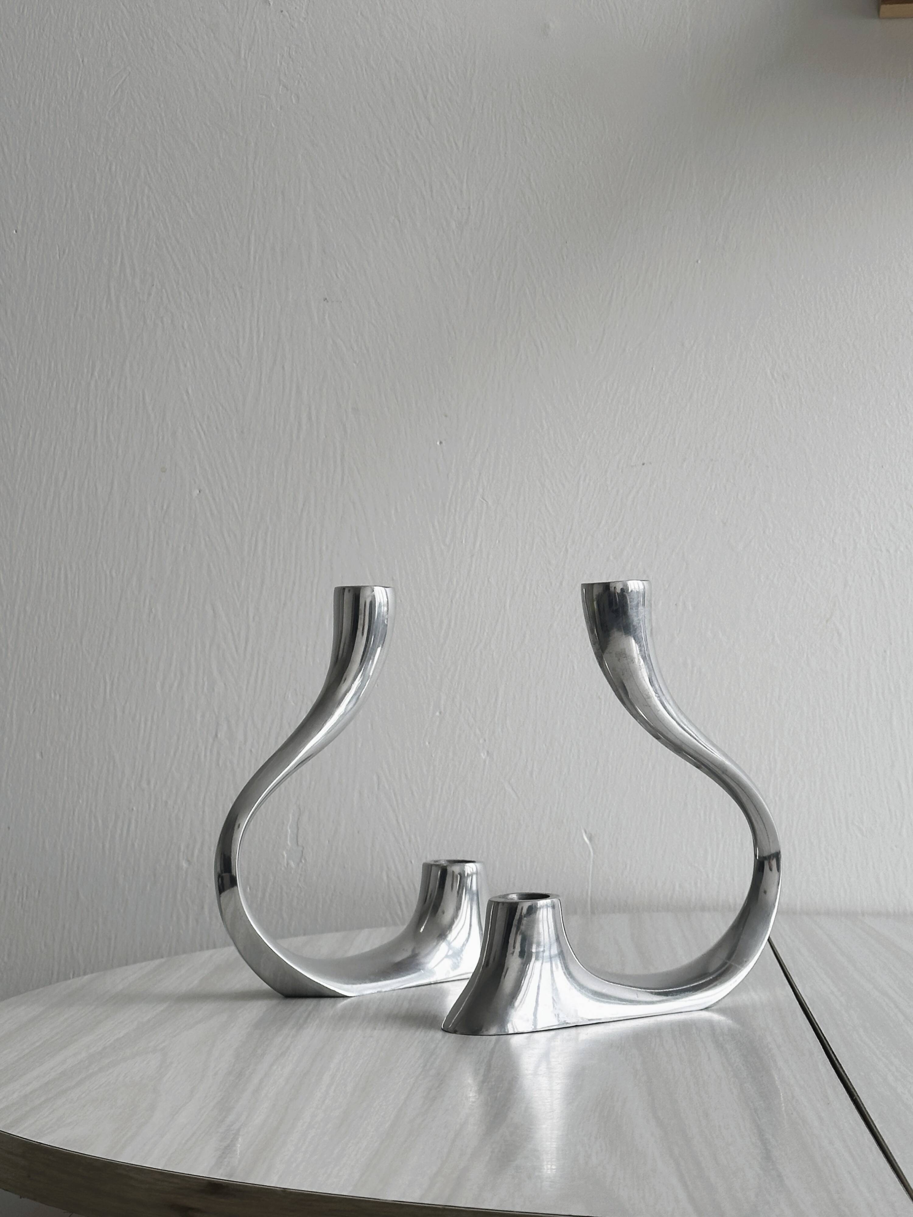 Pair of designer candlesticks in chromed metal