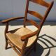 solid wood armchair, straw-covered seat