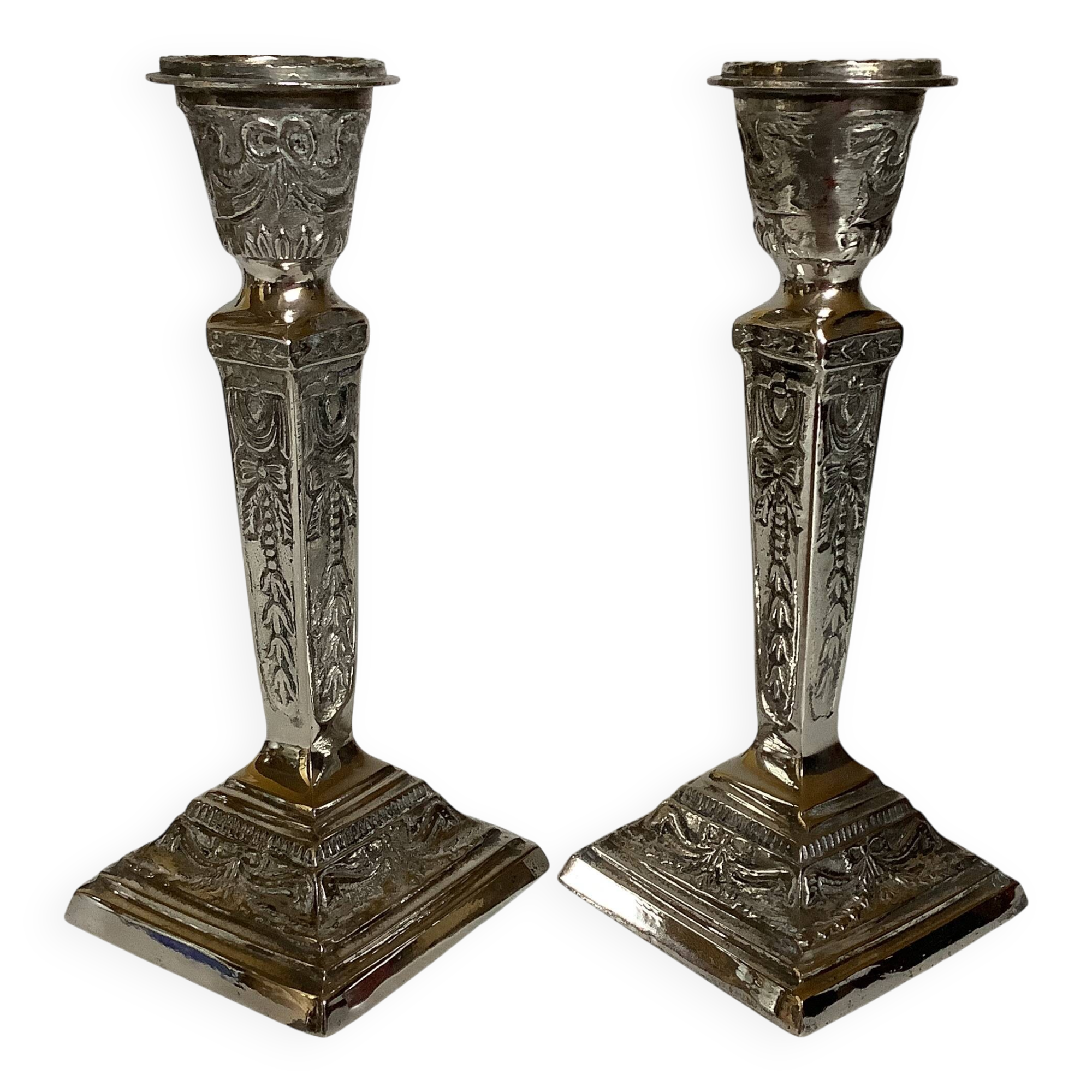 Pair of ornate silver candlesticks