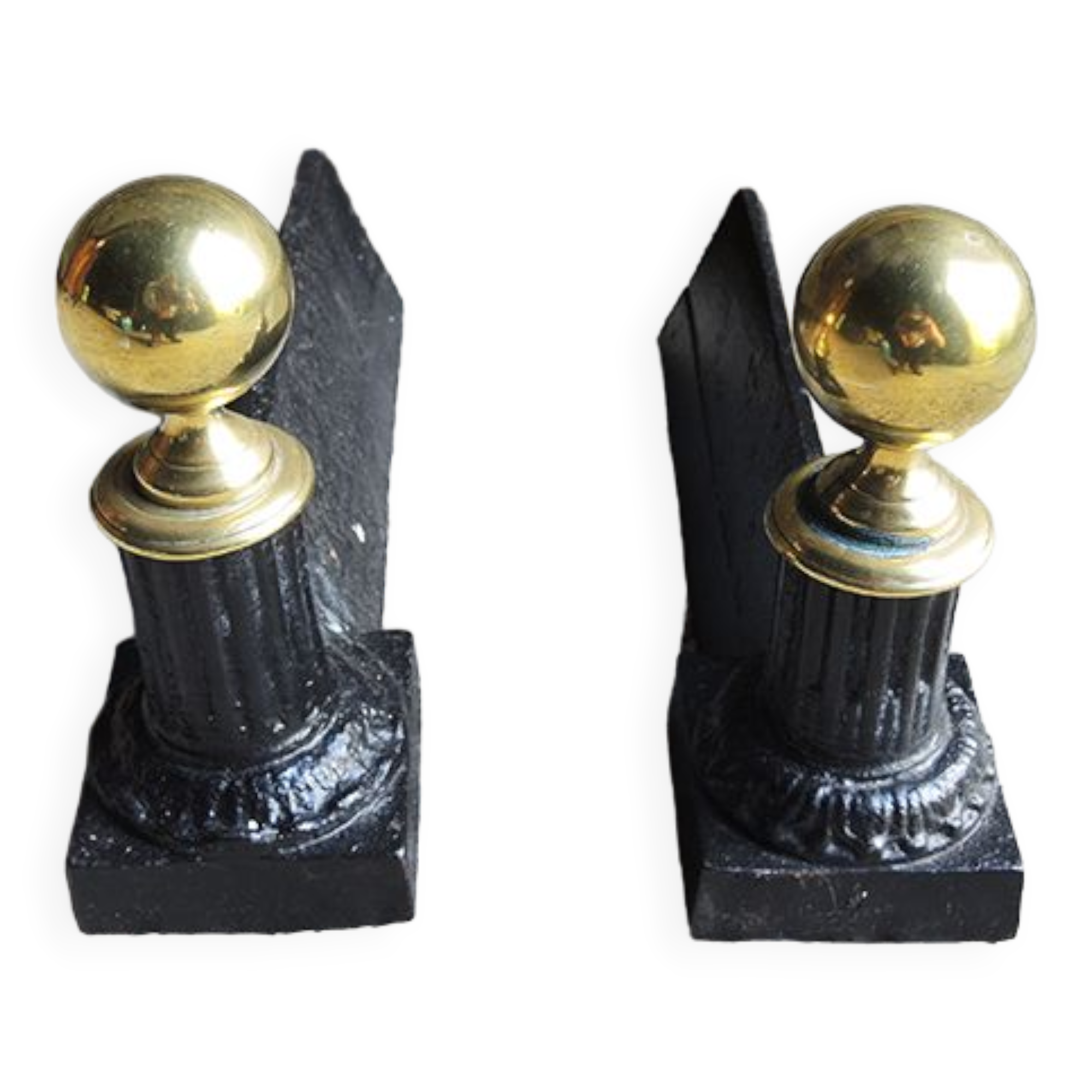 Old cast iron and brass andirons in neoclassical style