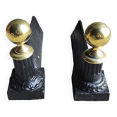 Old cast iron and brass andirons in neoclassical style