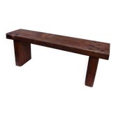 Brutalist wooden bench made of solid oak beam.
