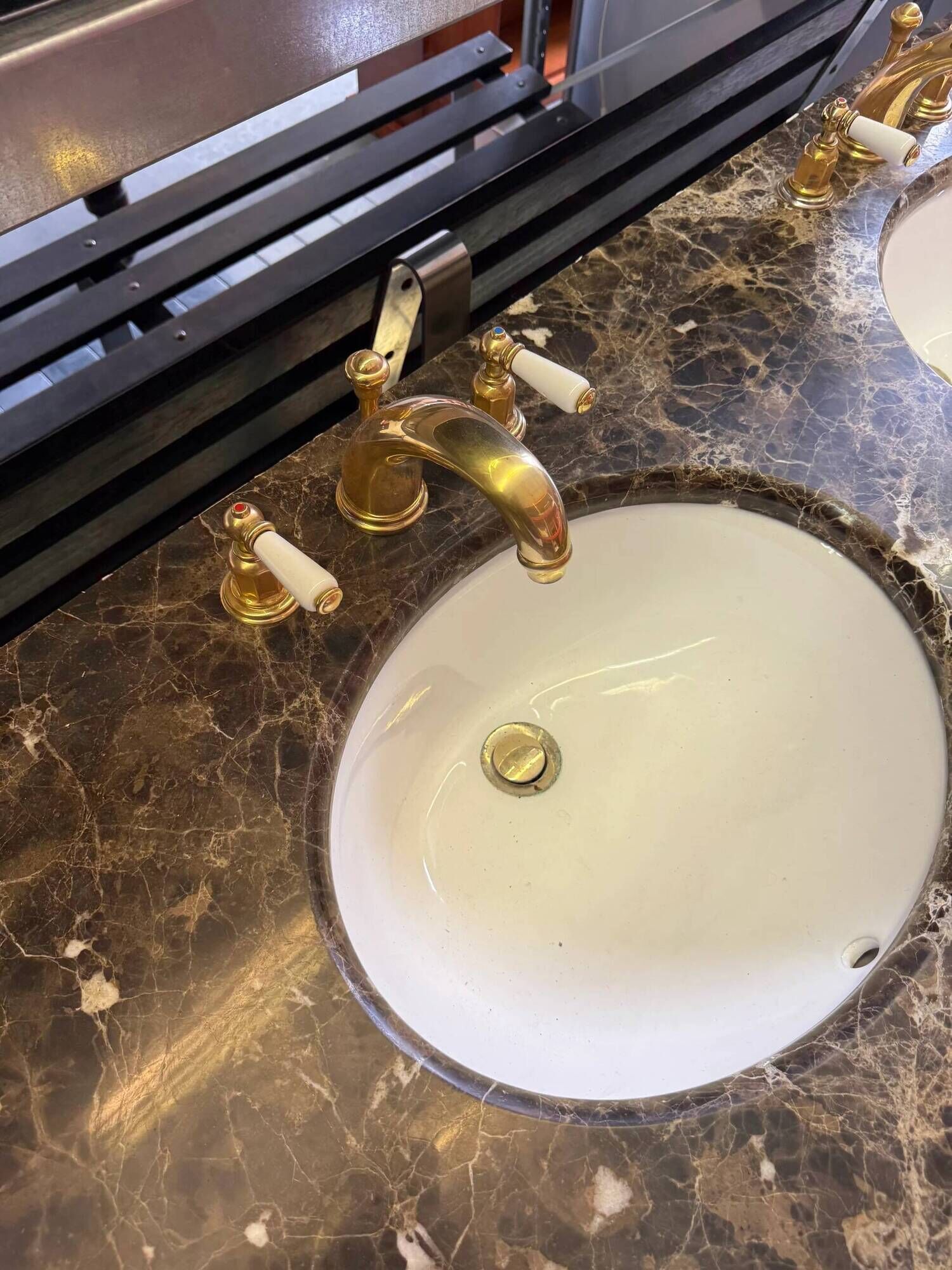 Classic double bathroom cabinet with marble top and gold fittings