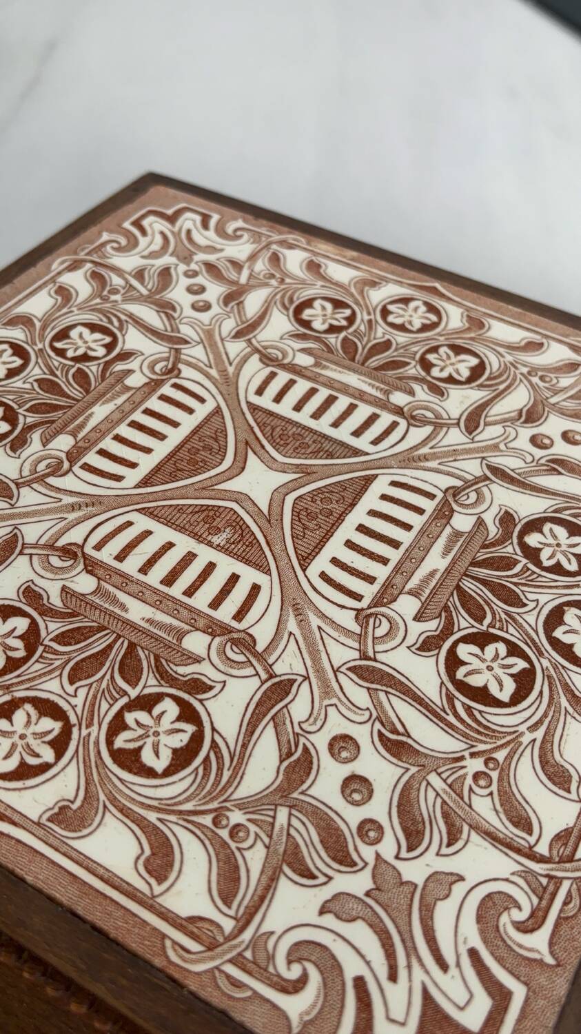 Vintage wooden and antique earthenware trivet, brown tile design