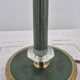 Brass table lamp with green patina and empire-style fabric shade.
