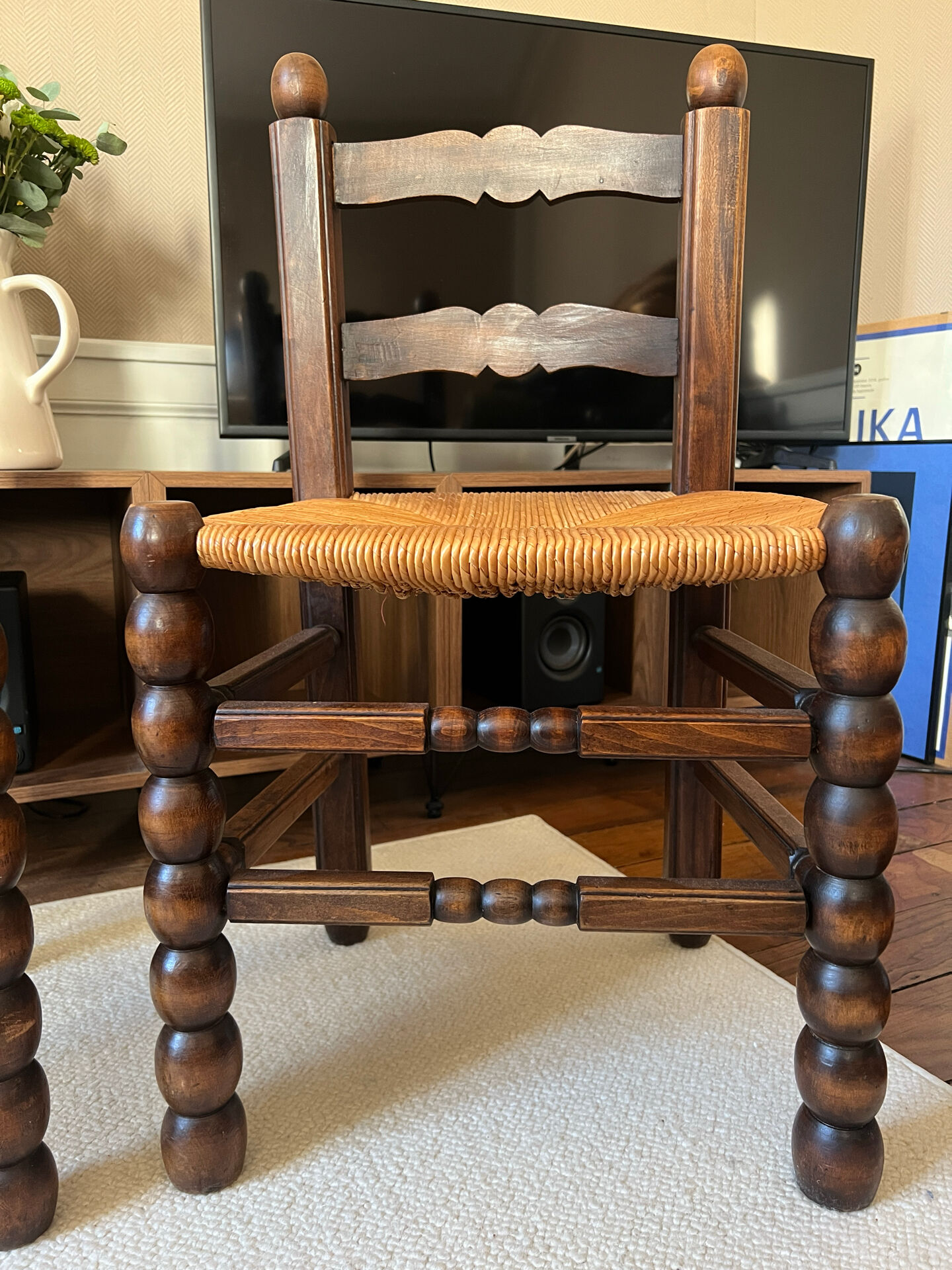 Pair of vintage armchairs with turned wood and woven rope seat.
