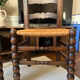 Pair of vintage armchairs with turned wood and woven rope seat.