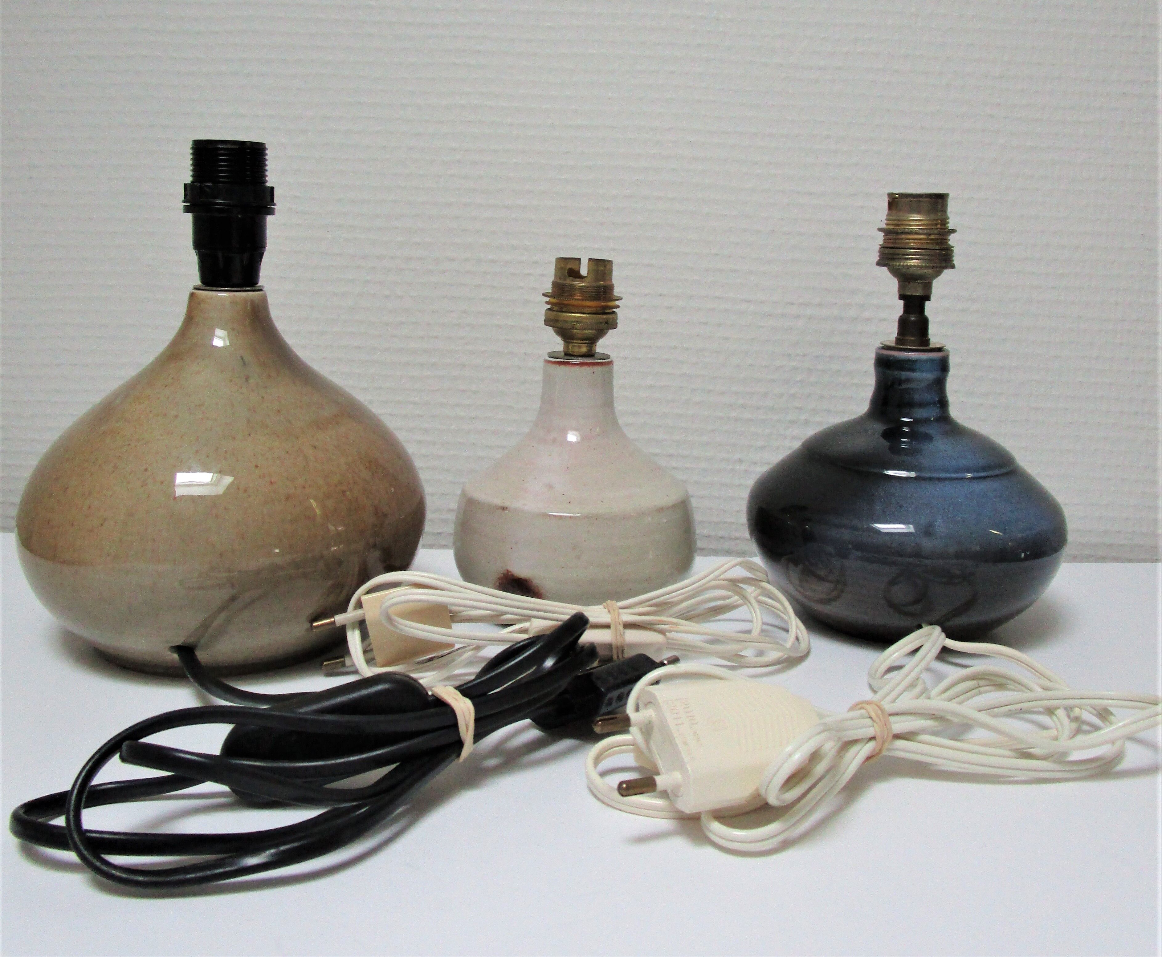 Three vintage ceramic lamps in blue, white and suede