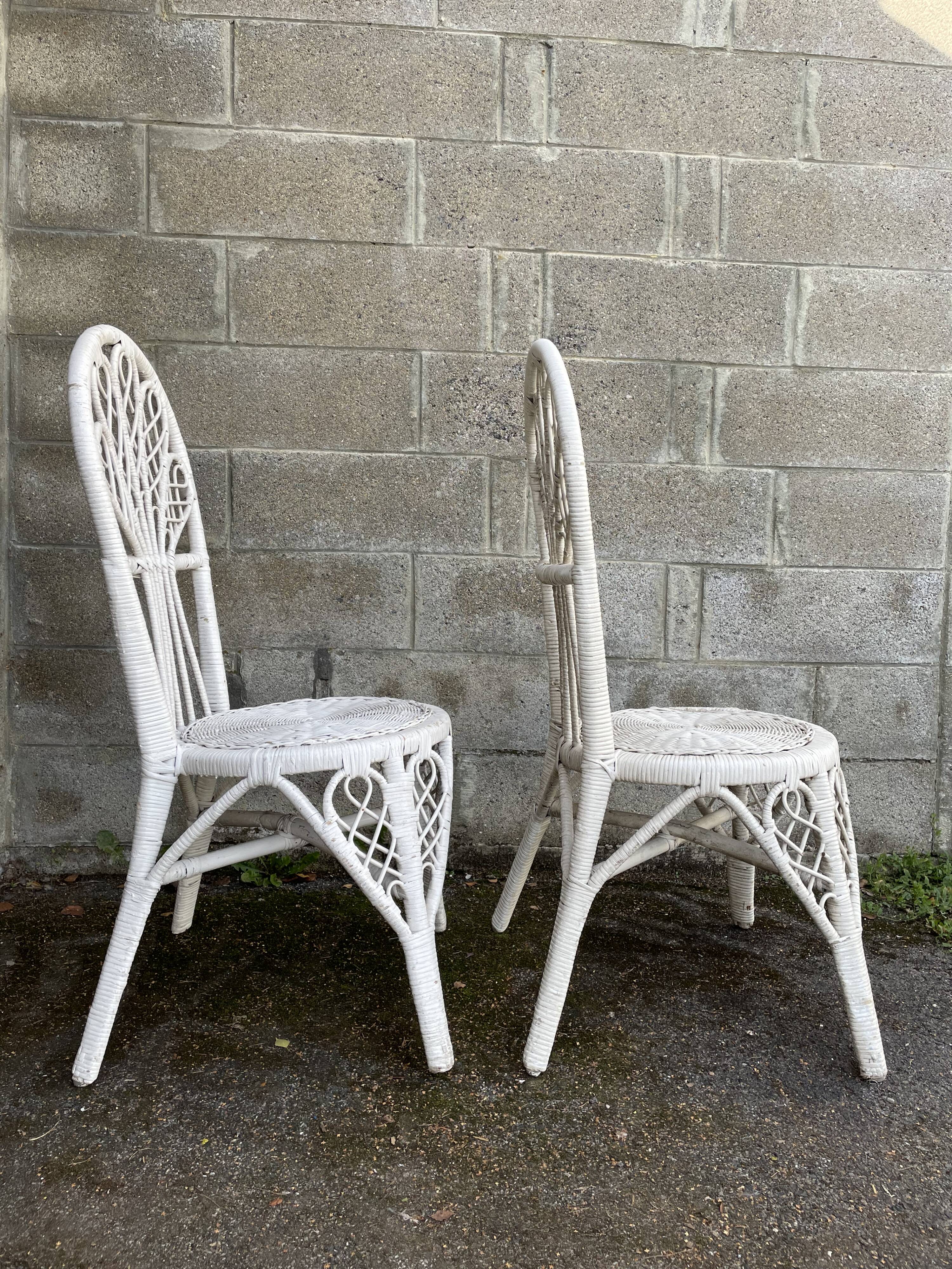 Pair of white peacock rattan chairs, circa 1960