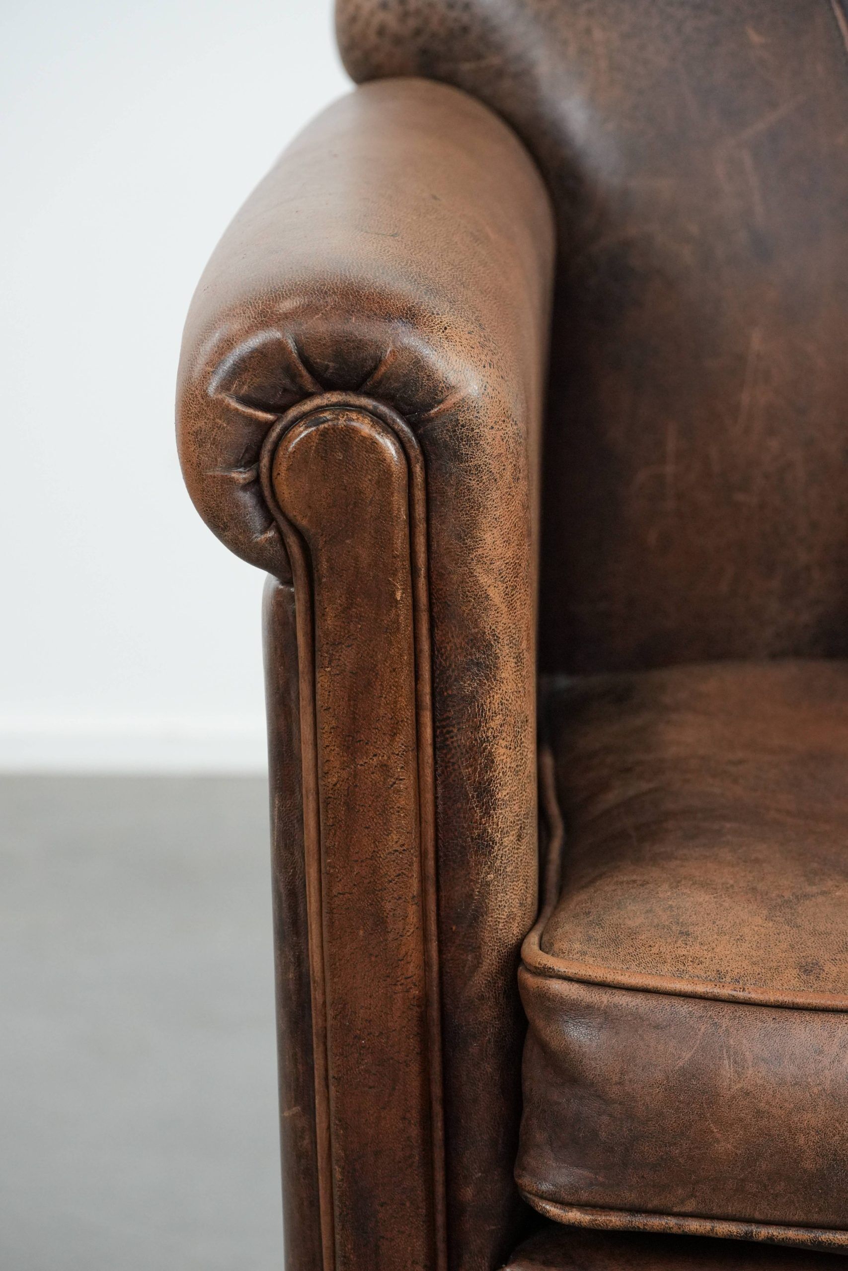 Vintage sheepskin armchair with warm colours and a characterful appearance