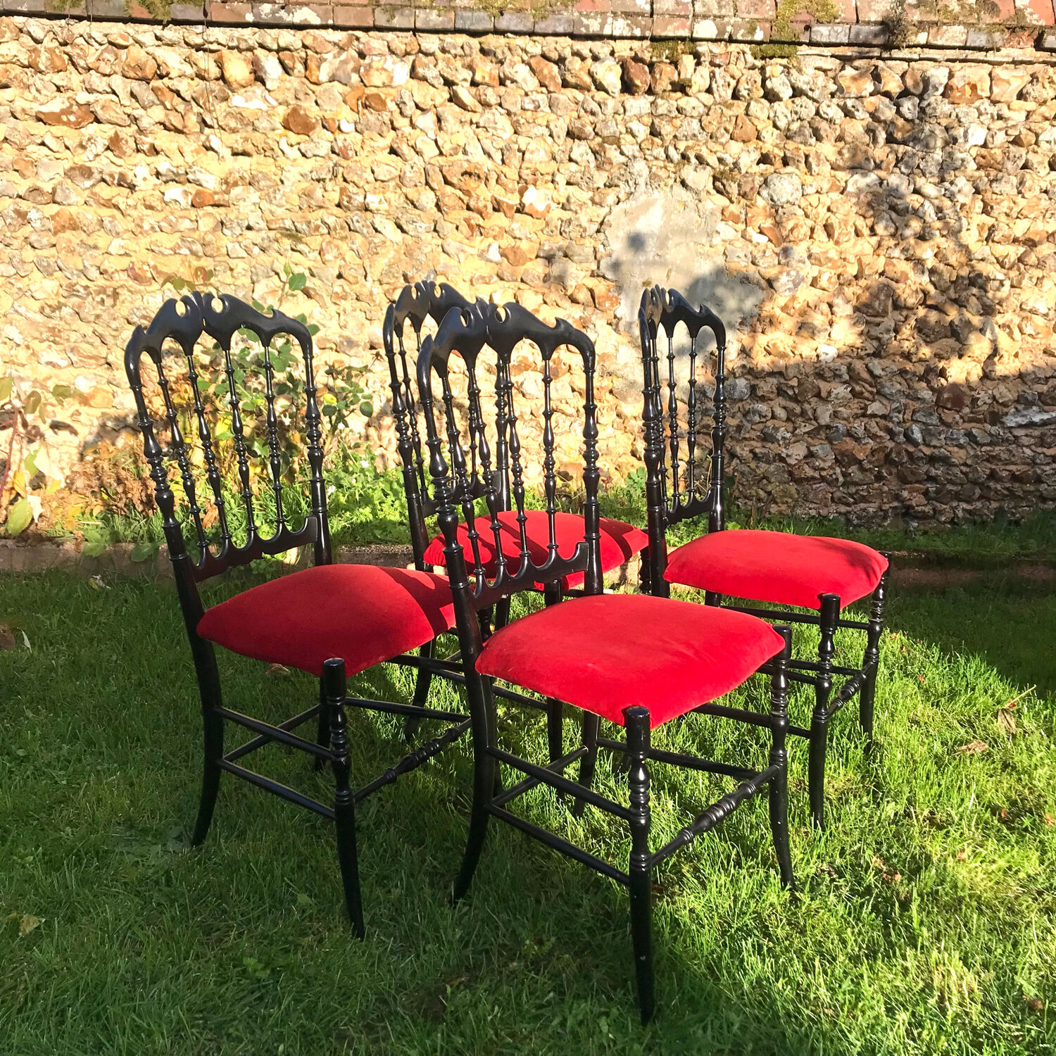 4 black reception chairs with red seats