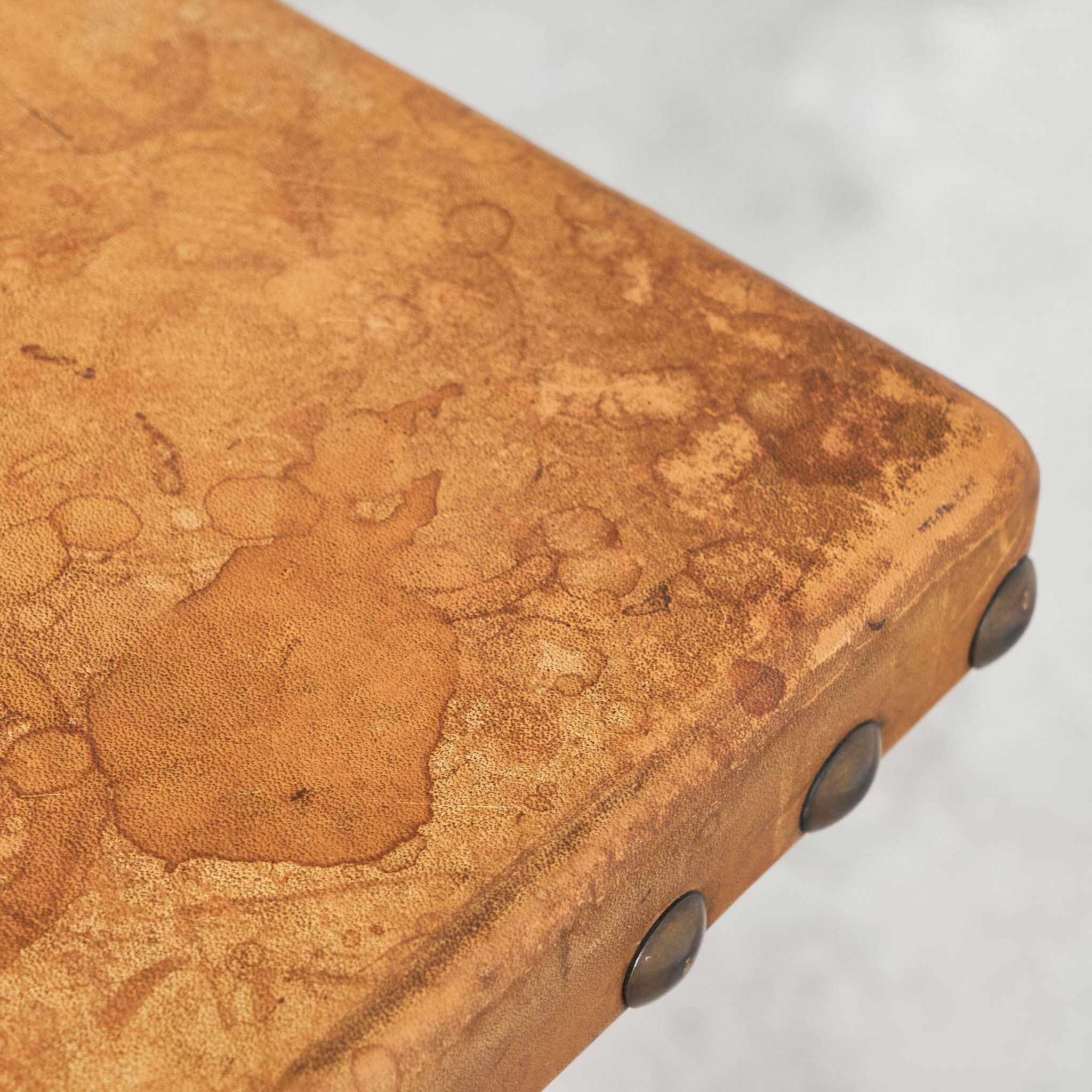 Brutalist coffee table in solid oak, metal, and patinated leather, 1940s.