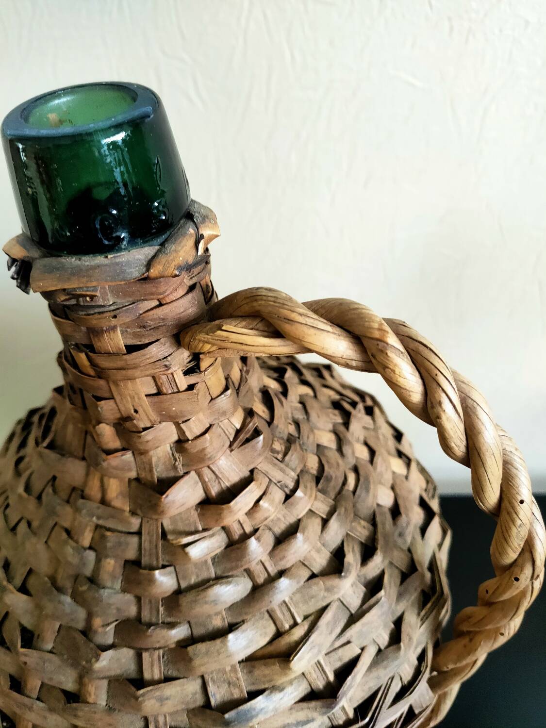 Antique demijohn made of glass and woven wicker