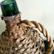 Antique demijohn made of glass and woven wicker