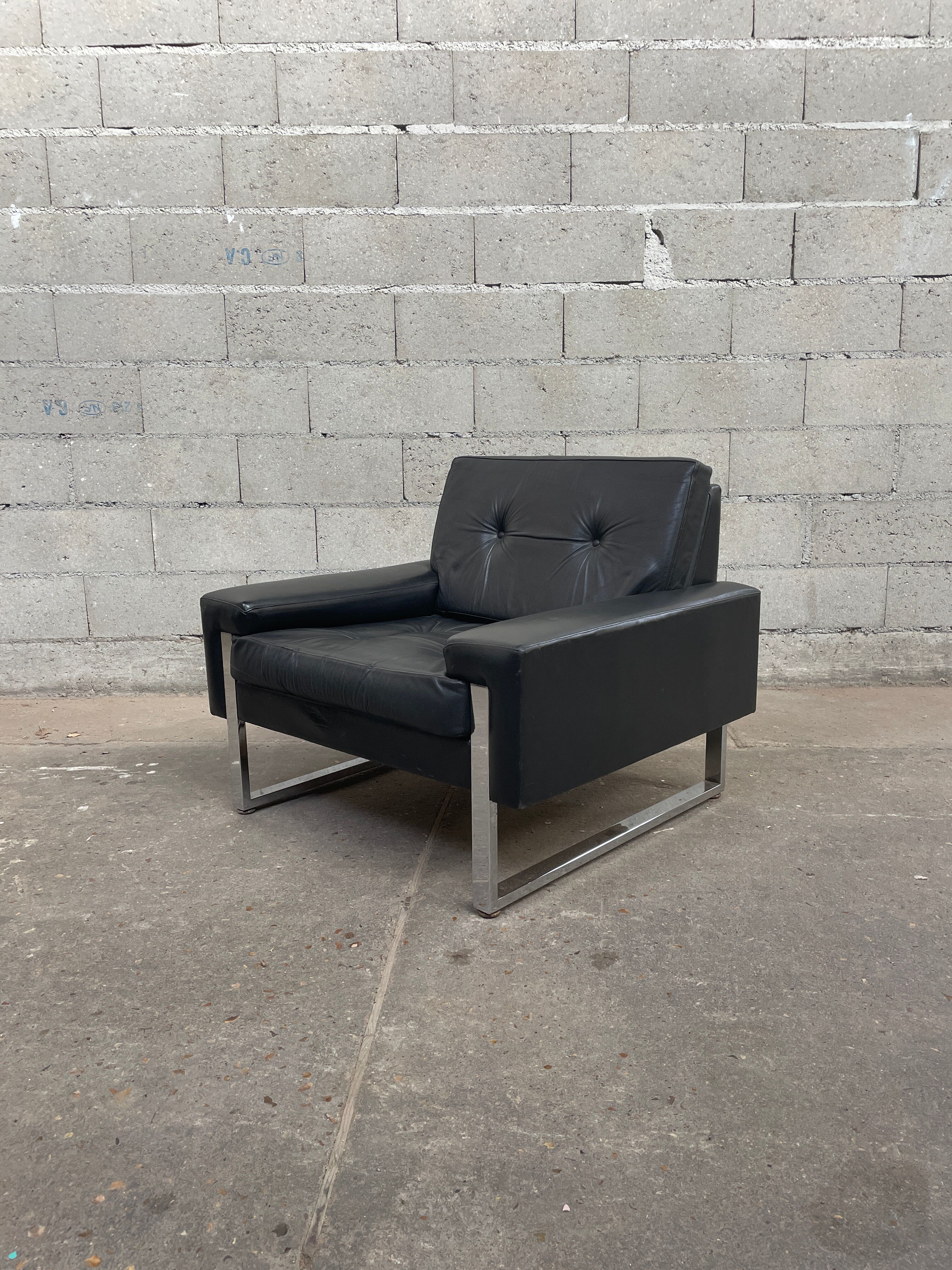 Pair of black leather armchairs