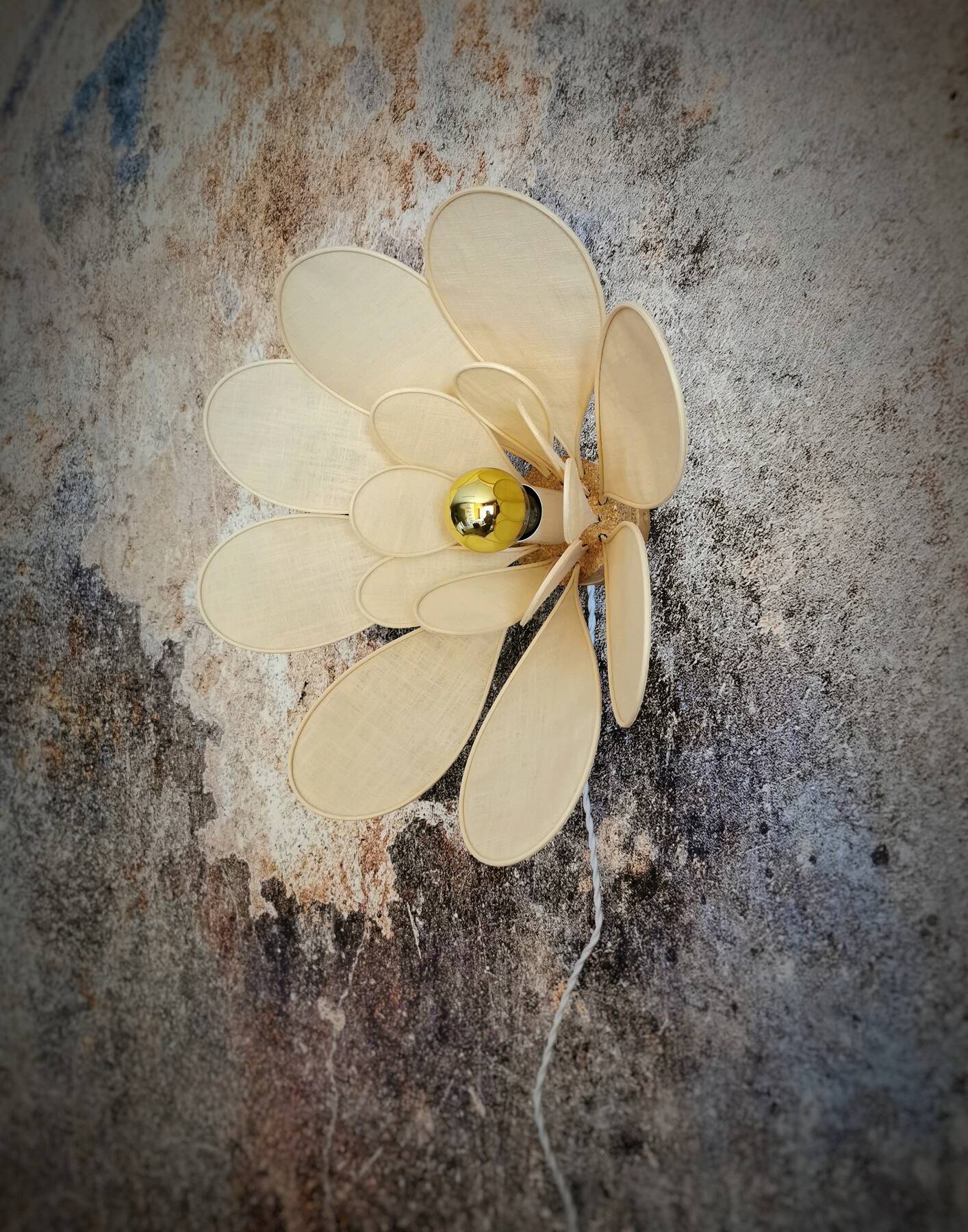 Flower wall light made of rattan and sand linen petals