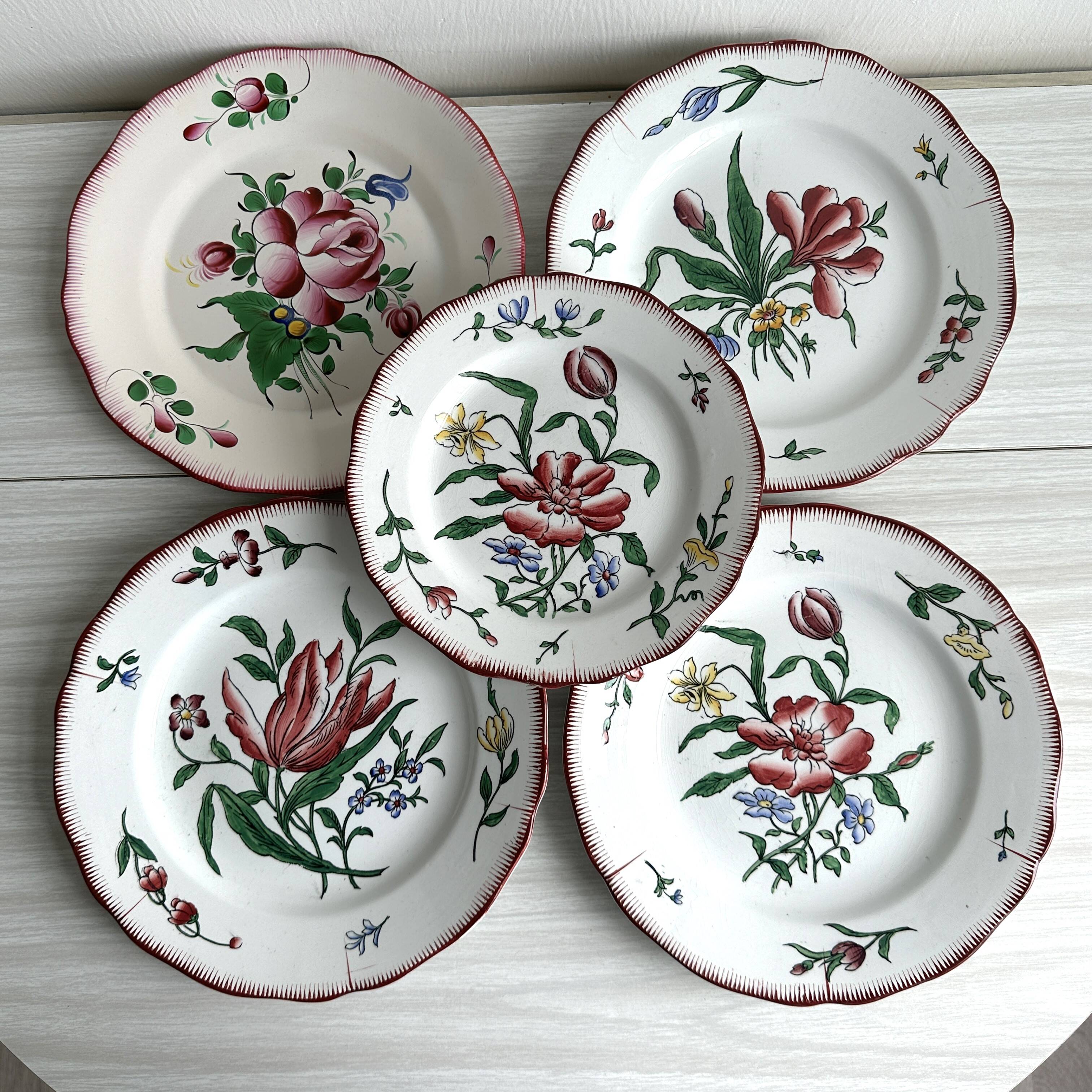 5 plates with colorful Sarreguemines floral designs.
