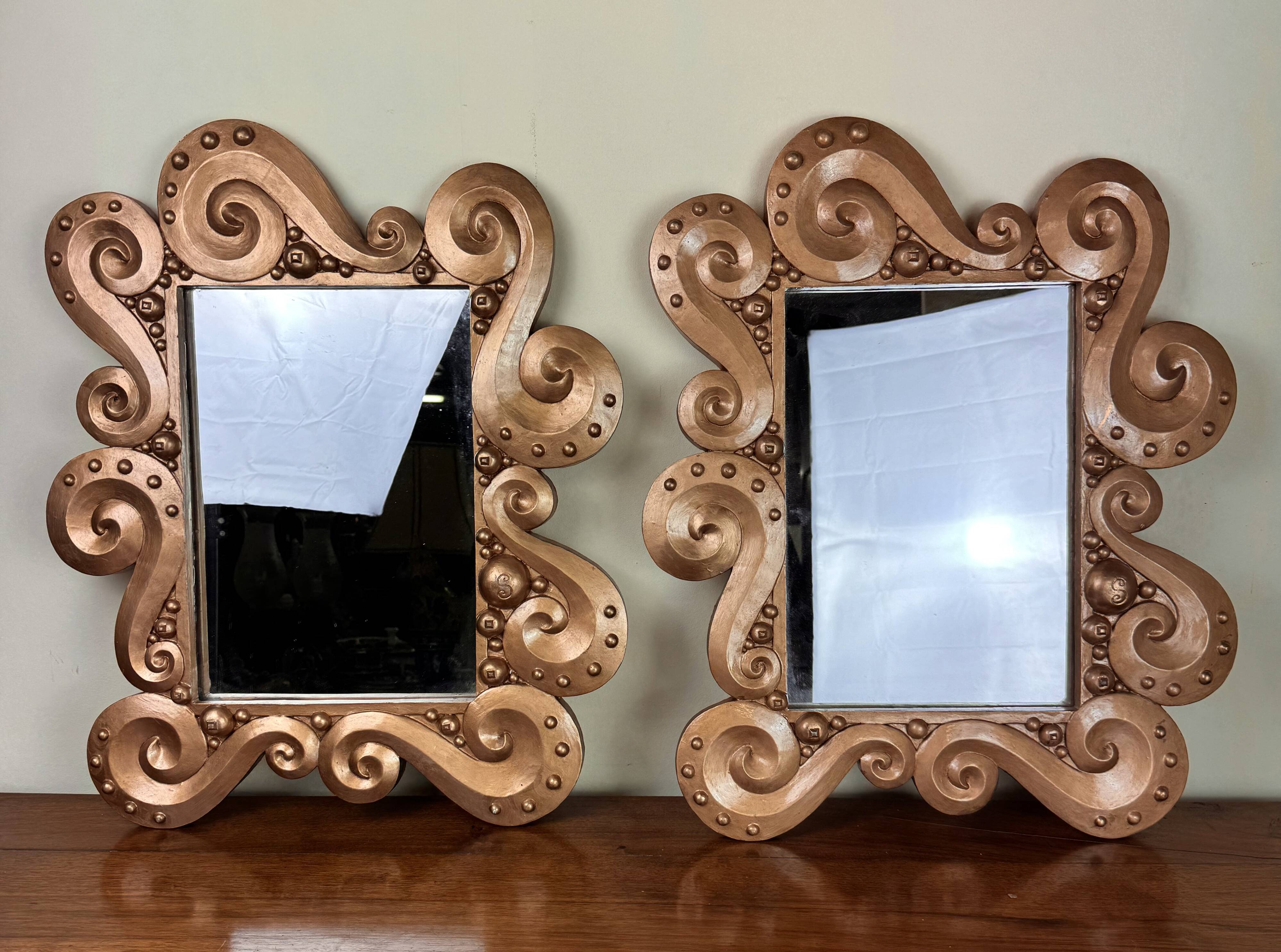 According to the model “the waves” by Jean Boggio: pair of designer gold mirrors circa 1980