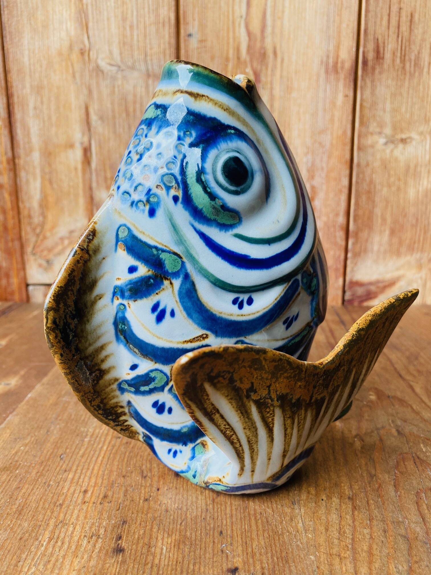 Blue ceramic zoomorphic vase in the shape of a poison.