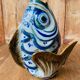 Blue ceramic zoomorphic vase in the shape of a poison.