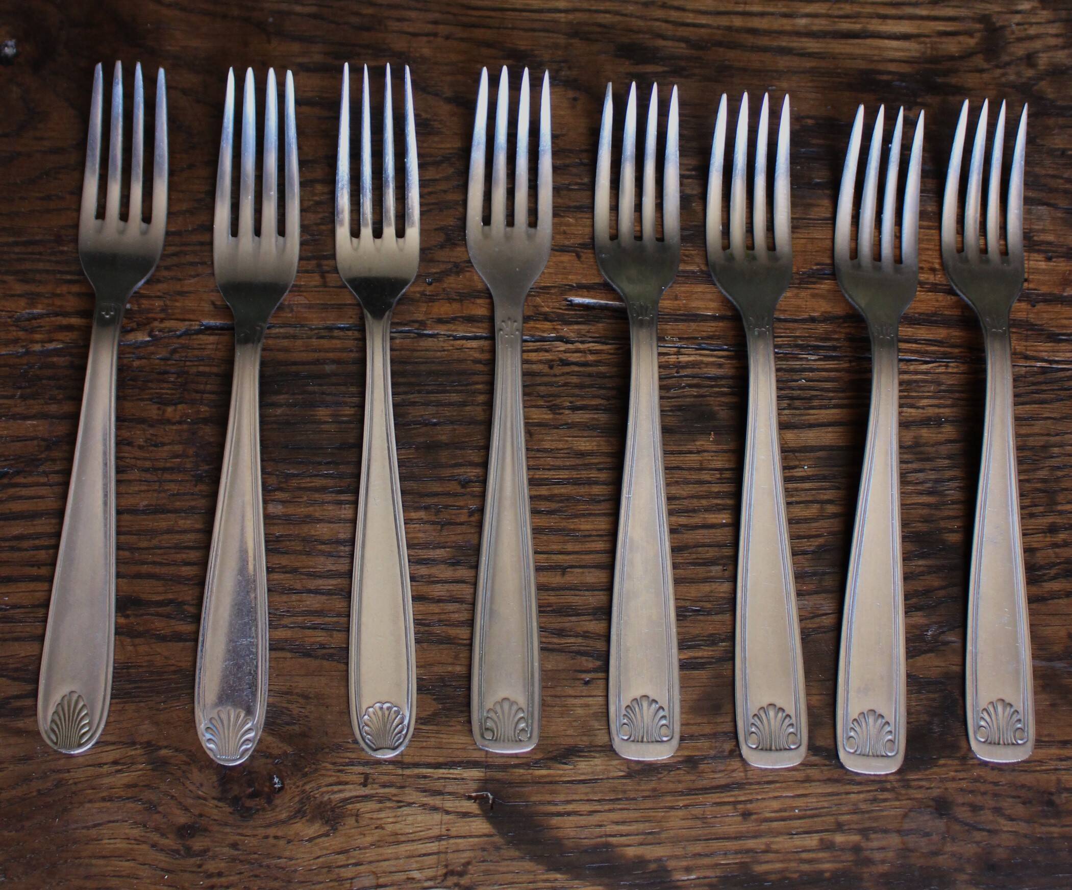 Mismatched set of 8 forks + 8 vintage shell stainless steel knives