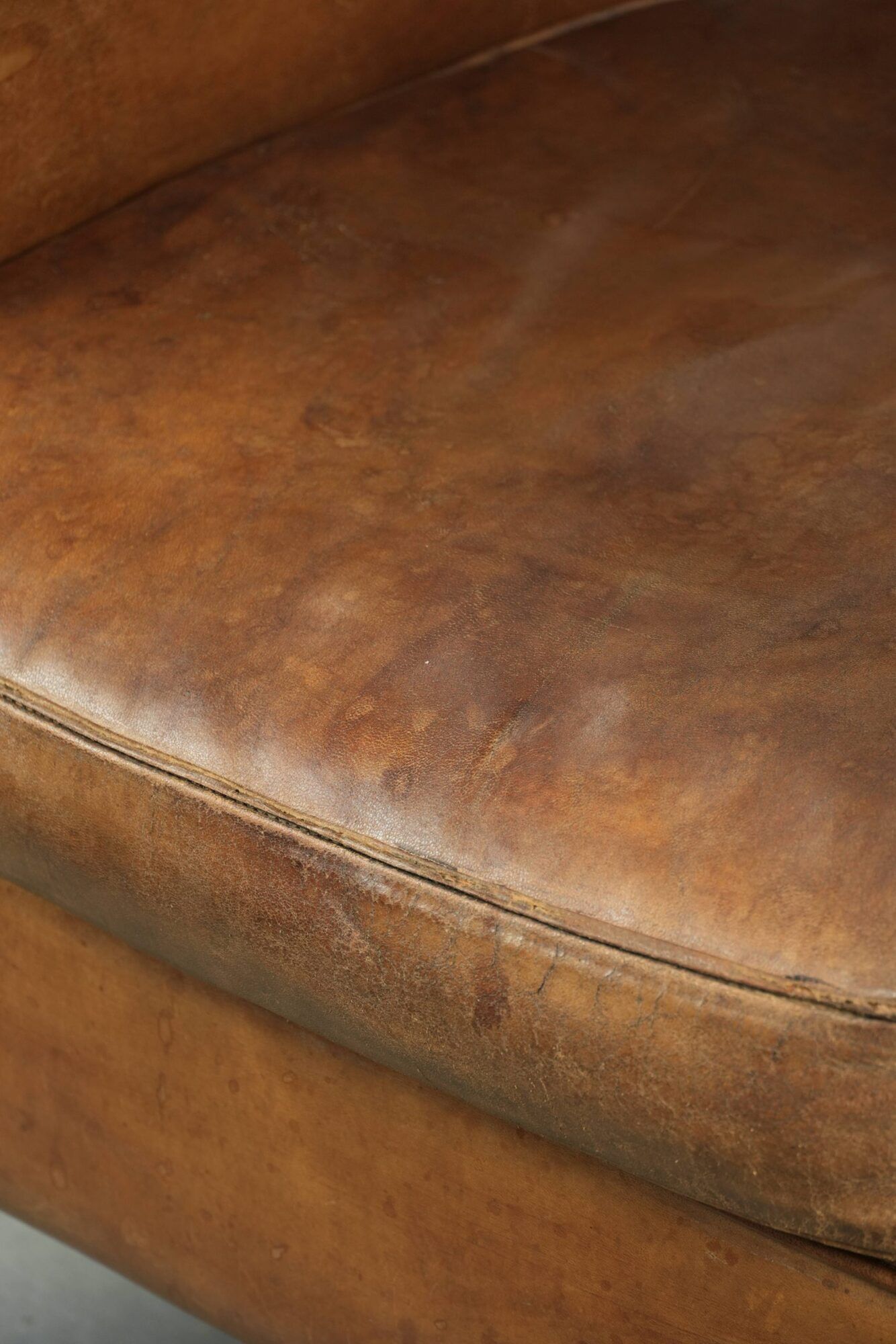 Vintage sheepskin club armchair finished with decorative nails