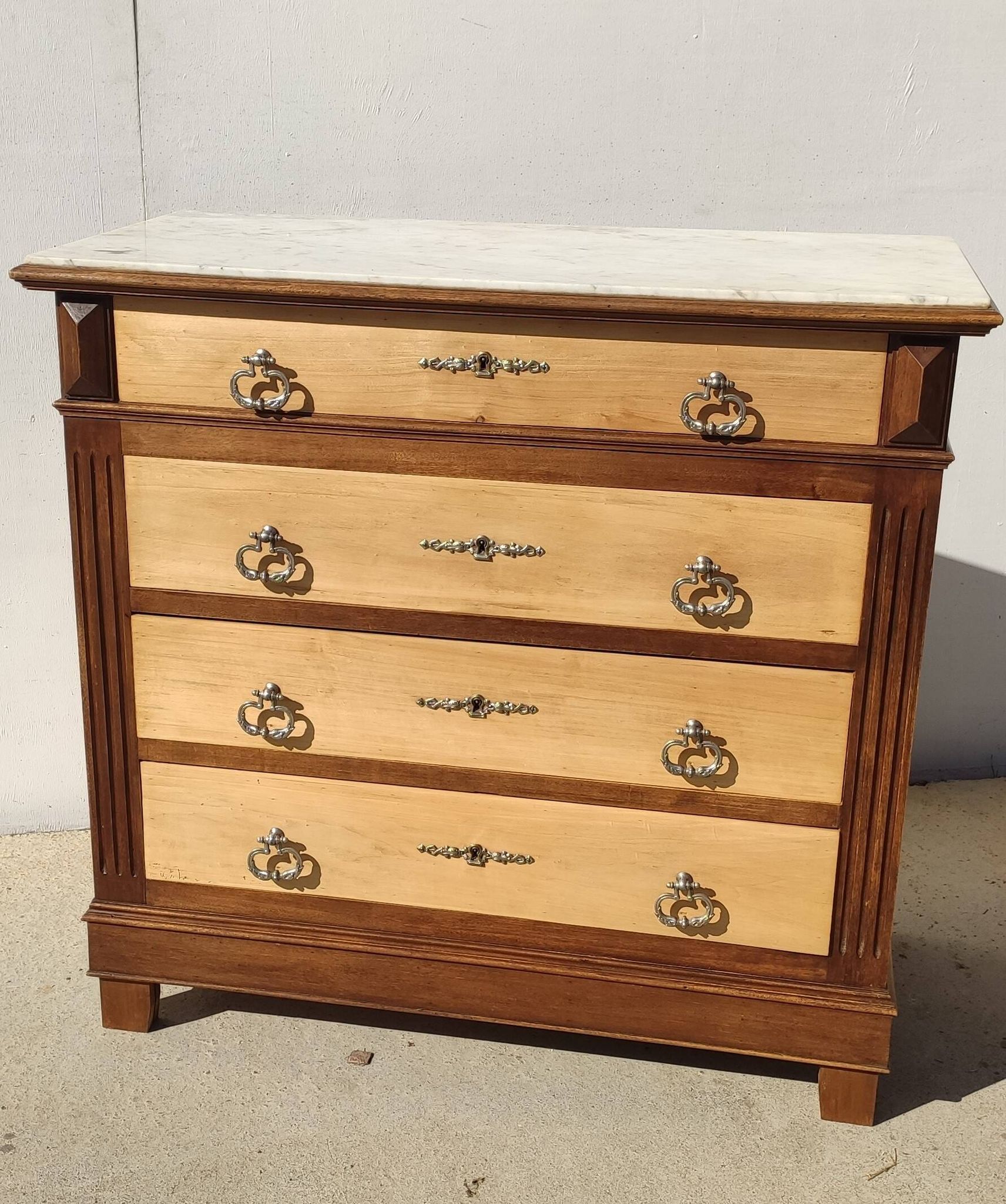 Old chest of drawers with white marble.