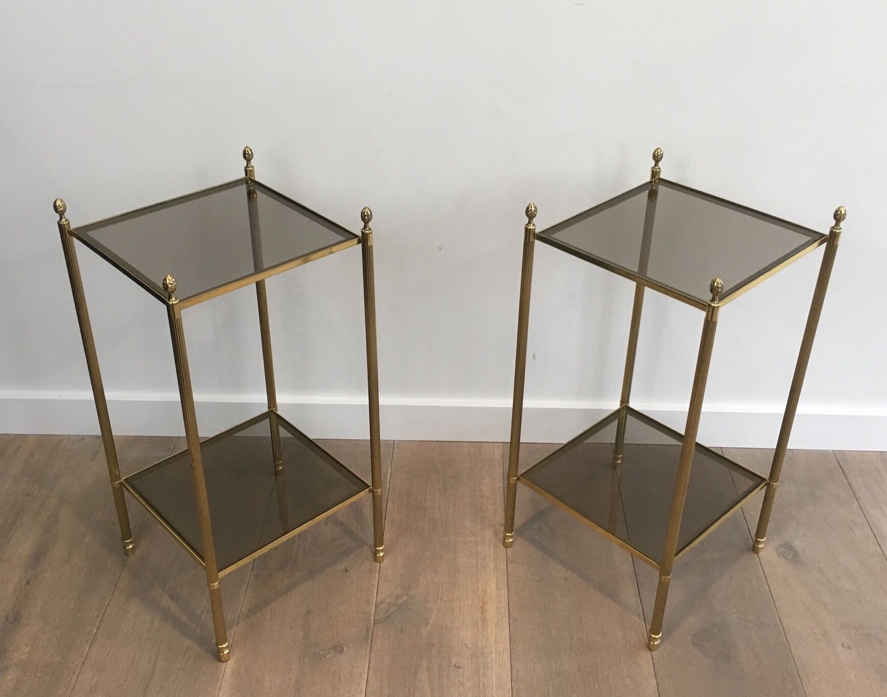 Pair of neoclassical style sofa ends in gilded metal and glass
