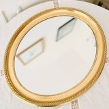 Oval wall mirror in gilded wood