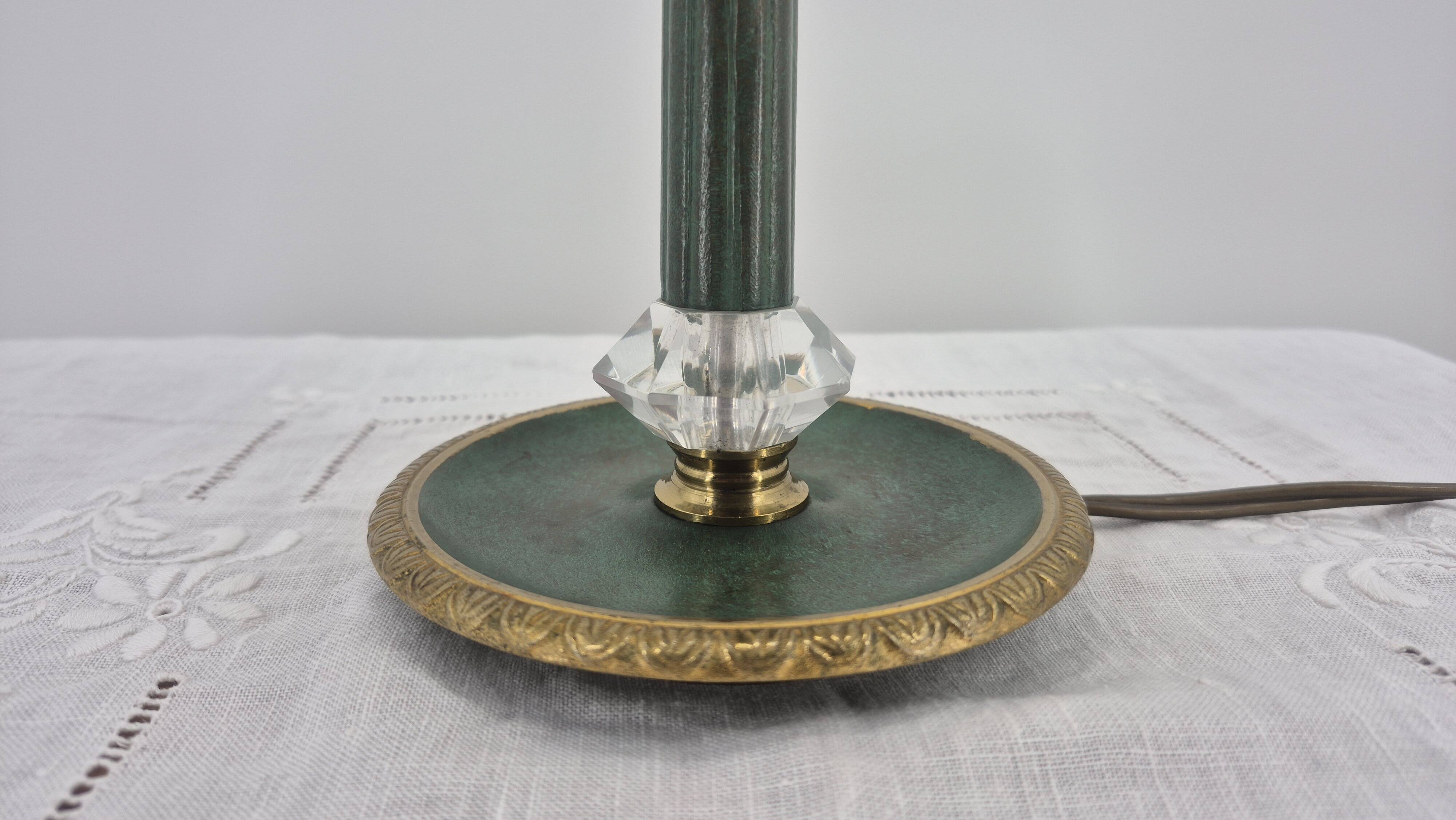 Brass table lamp with green patina and empire-style fabric shade.