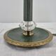 Brass table lamp with green patina and empire-style fabric shade.